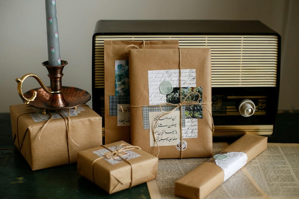 Rustic brown paper gifts with vintage radio and candle for a classic cozy atmosphere.